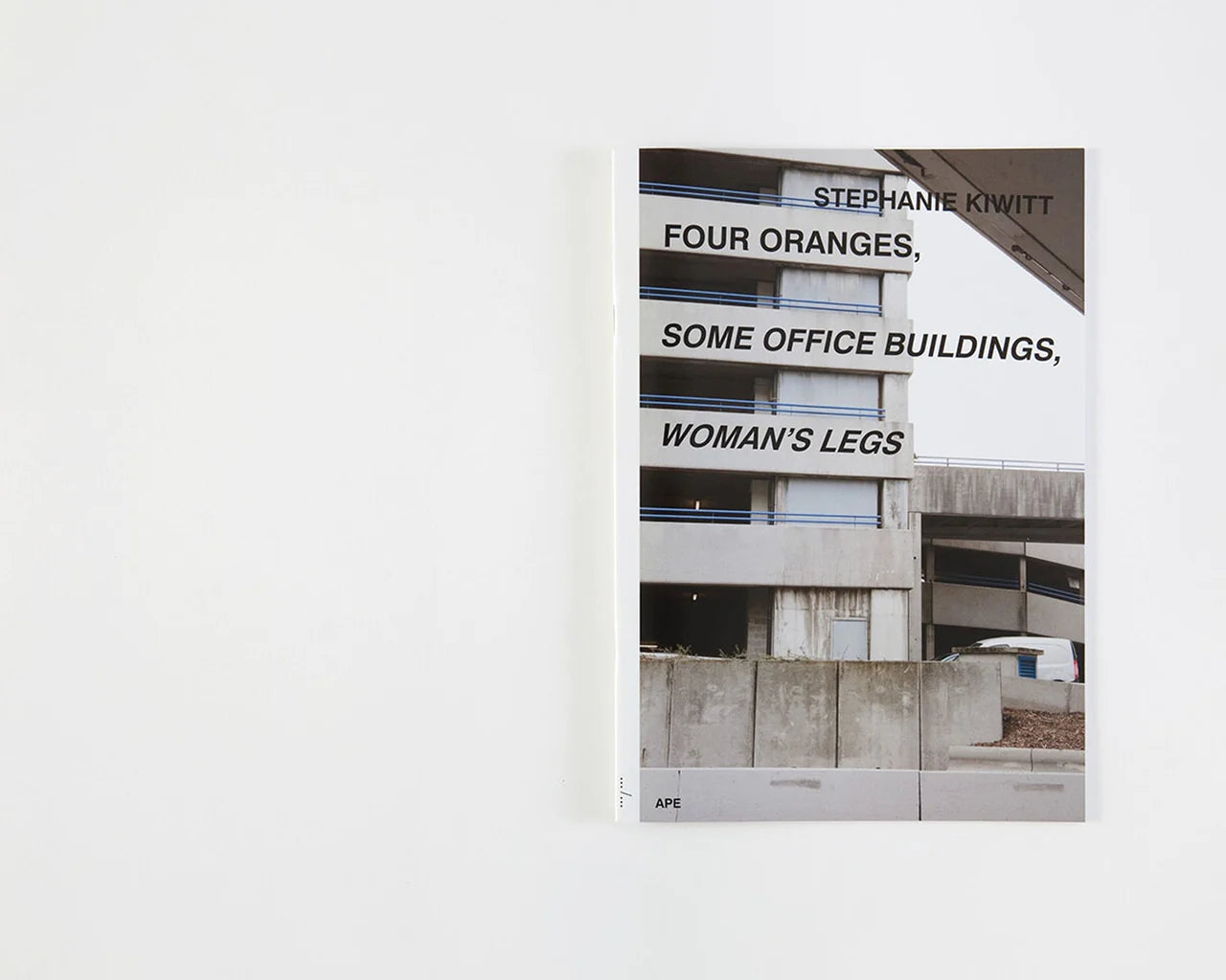 Four oranges, some office buildings, woman’s legs by Stephanie Kiwitt