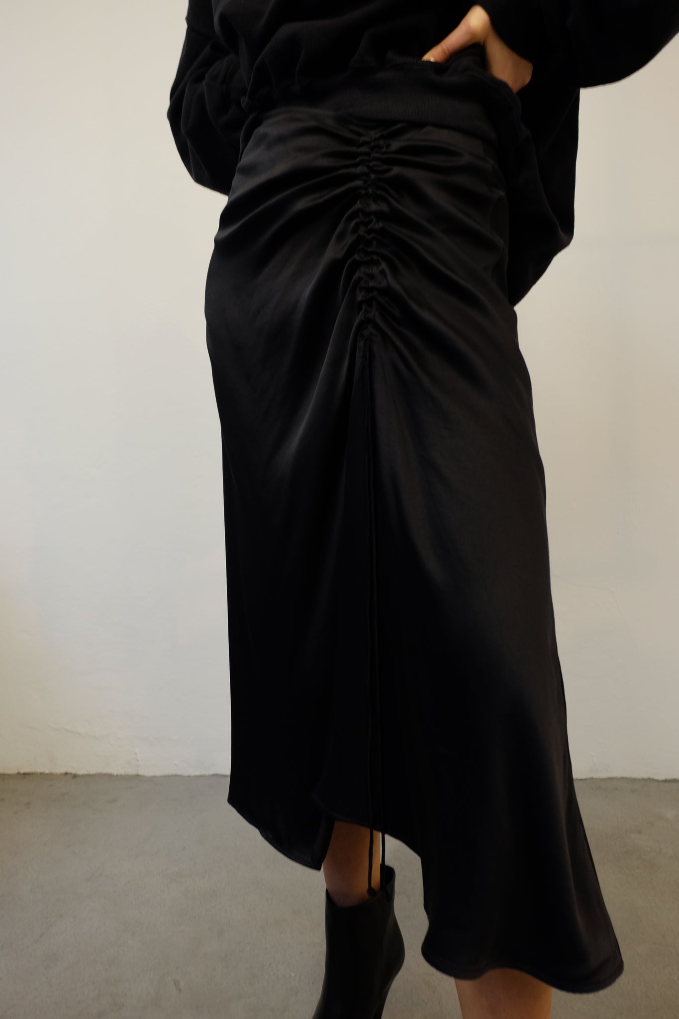 CIELO CORD DETAIL DRAPED SKIRT IN BLACK BY ÁERON